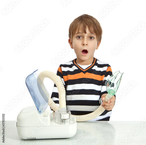 Photo: little boy makes inhalation with nebuliser little boy makes inhalation with nebuliser