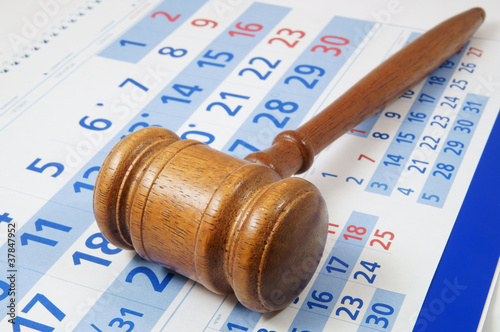 Photo: Wooden gavel on paper calendar Wooden gavel on paper calendar