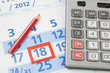 Photo: Calculator and red pencil on calendar Calculator and red pencil on calendar