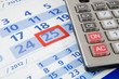 Photo: Calculator on calendar background Calculator on calendar background