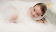 Foto: Little girl in soap foam Little girl in soap foam