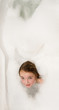 Foto: Little girl in soap foam Little girl in soap foam
