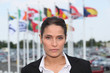 Brunette stood in front of flags