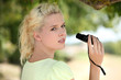 Woman using pair of binoculars