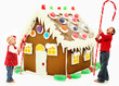 Photo: Boy and Girl Children Building Giant Gingerbread House Boy and Girl Children Building Giant Gingerbread House