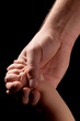 the hands of father and child