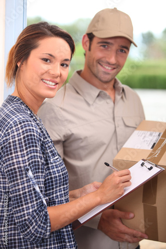 Photo: Courier with a signed-for delivery Courier with a signed-for delivery
