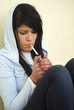 Girl is lighting a cigarette