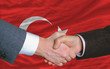 businessmen handshake after good deal in front of turkey flag