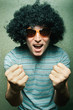 crazy young guy in afro curly wig with eyeglasses
