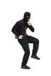 Robber with finger on the lips gesturing silence