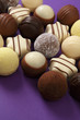 Photo: Chocolates and truffles on purple Chocolates and truffles on purple