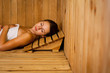 Young woman relaxing in a sauna