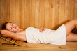 Young woman relaxing in a sauna