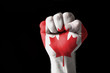 Fist painted in colors of canada flag Fist painted in colors of canada flag