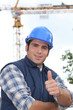 A construction worker giving the thumb up.