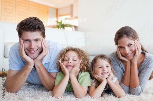 Photo: Family lying on a carpet Family lying on a carpet