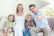 Family watching television on the sofa