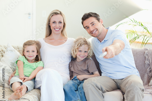 Photo: Family watching television on the sofa Family watching television on the sofa