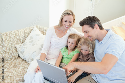 Photo: Family on the couch with laptop Family on the couch with laptop