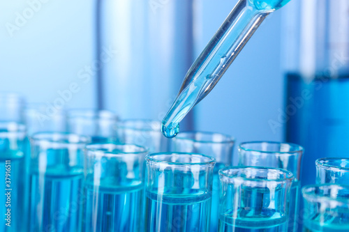 Foto: Test-tubes on blue background Test-tubes on blue background