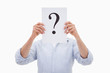 Portrait of a man hiding his face behind a question mark