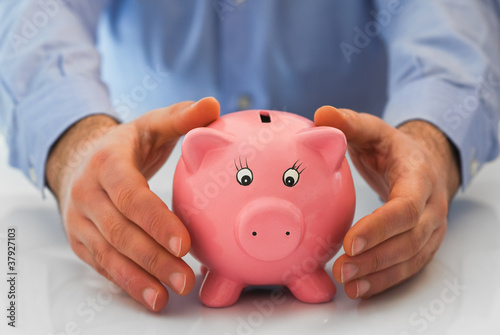Photo: Man with piggy bank. Man with piggy bank.