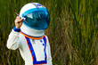 child wearing astronaut helmet playing with toy airplane