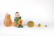 Baby in a Halloween pumpkin costume