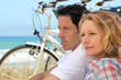 Couple with bicycles by the coast