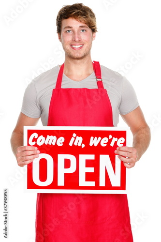 Photo: Business shop owner showing open sign Business shop owner showing open sign