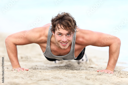 Photo: Fitness man exercising pushups Fitness man exercising pushups
