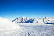 The view of winter mountains, ski slope on the foreground