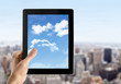 Hand Holds Tablet PC With Sky On Screen Hand Holds Tablet PC With Sky On Screen