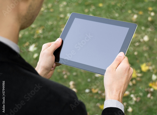 Foto: Businessman Holding A Tablet PC Businessman Holding A Tablet PC