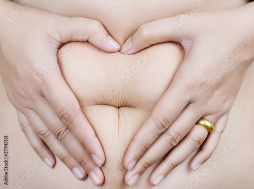 Photo: Stomach fat female body part to heart symbol. Stomach fat female body part to heart symbol.