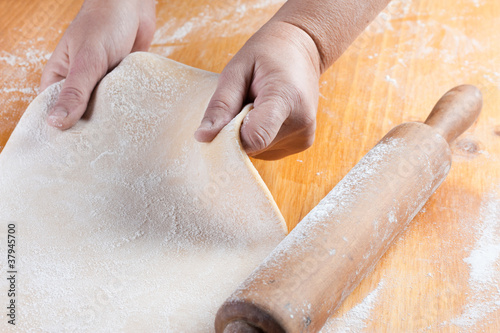 Photo: stretched dough with a rolling pin stretched dough with a rolling pin