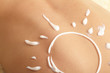 woman with sun-shaped sun cream
