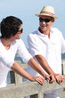 Men standing on a boardwalk