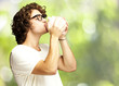 man kissing a piggybank