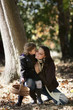 Little girl kissing her mum in woods