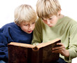 2 blonde boys reading fascinated together in an old book 2 blonde boys reading fascinated together in an old book