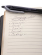 Shoping list and pen isolated on white
