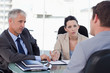 Photo: Business team negotiating with a customer Business team negotiating with a customer