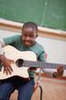 Portrait of a schoolboy playing the guitar