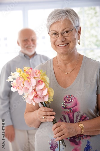 Photo: Portrait of senior woman with bouquet smiling Portrait of senior woman with bouquet smiling