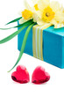 Two red glass hearts with a gift box and flowers, on white