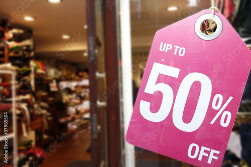 Photo: Sale signs in shop window Sale signs in shop window