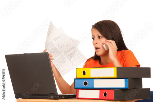 Photo: Attractive young brunette working on laptop Attractive young brunette working on laptop