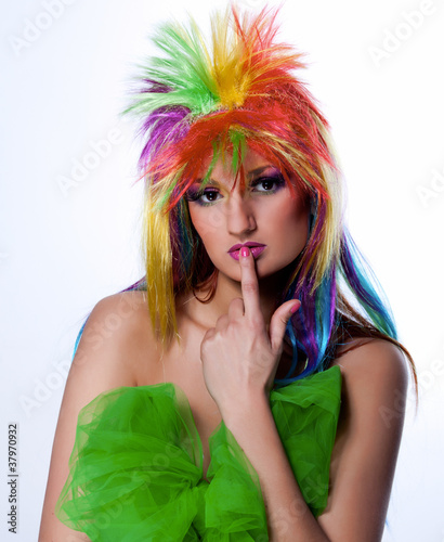 Photo: The beautiful young girl in a bright wig looking thoughtfully The beautiful young girl in a bright wig looking thoughtfully